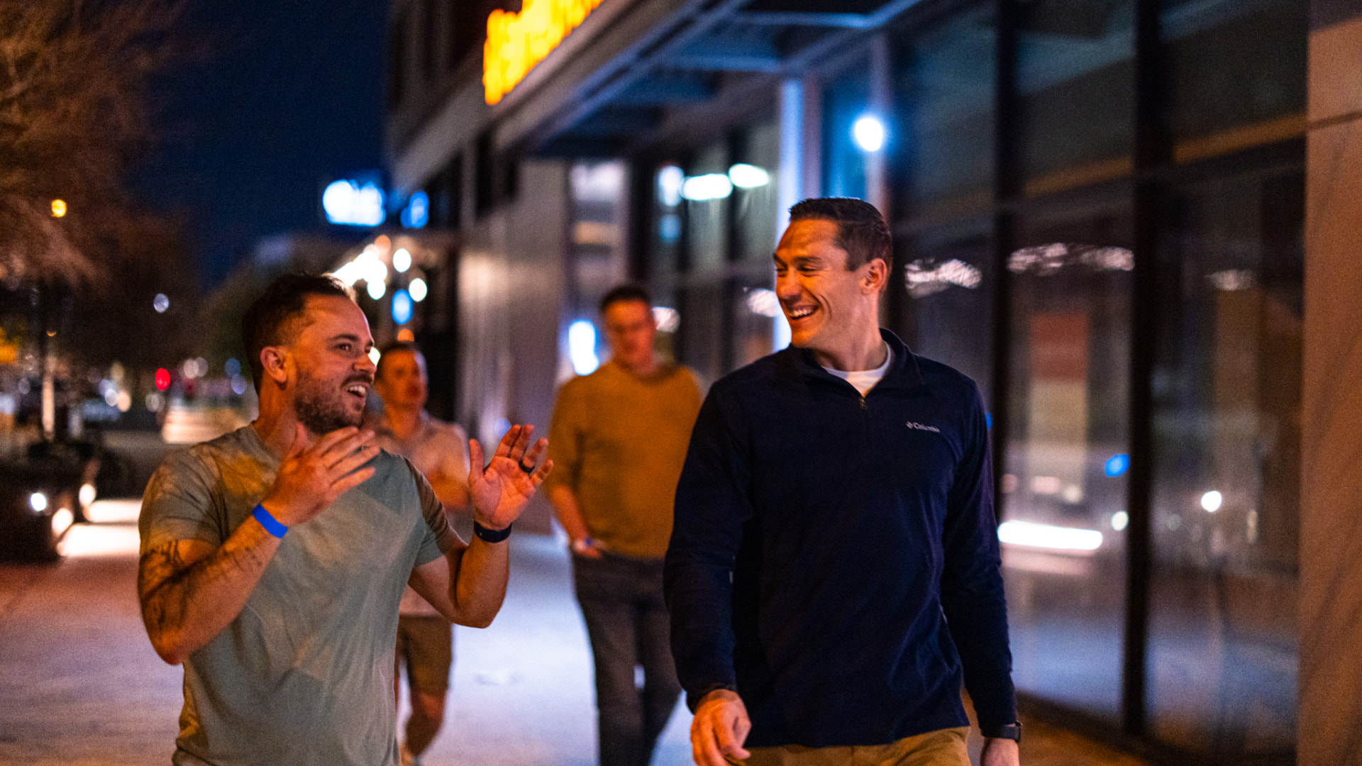 Attendees walking and laughing downtown at night
