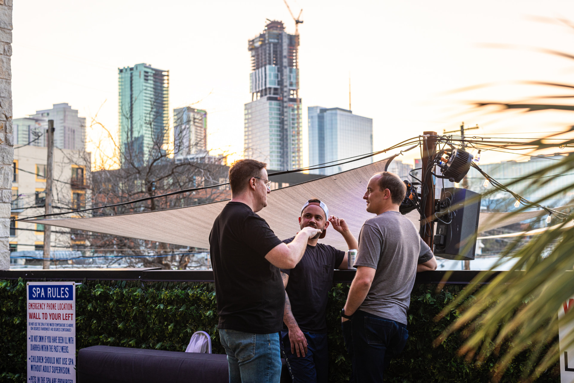 Attendees chatting over drinks on the patio